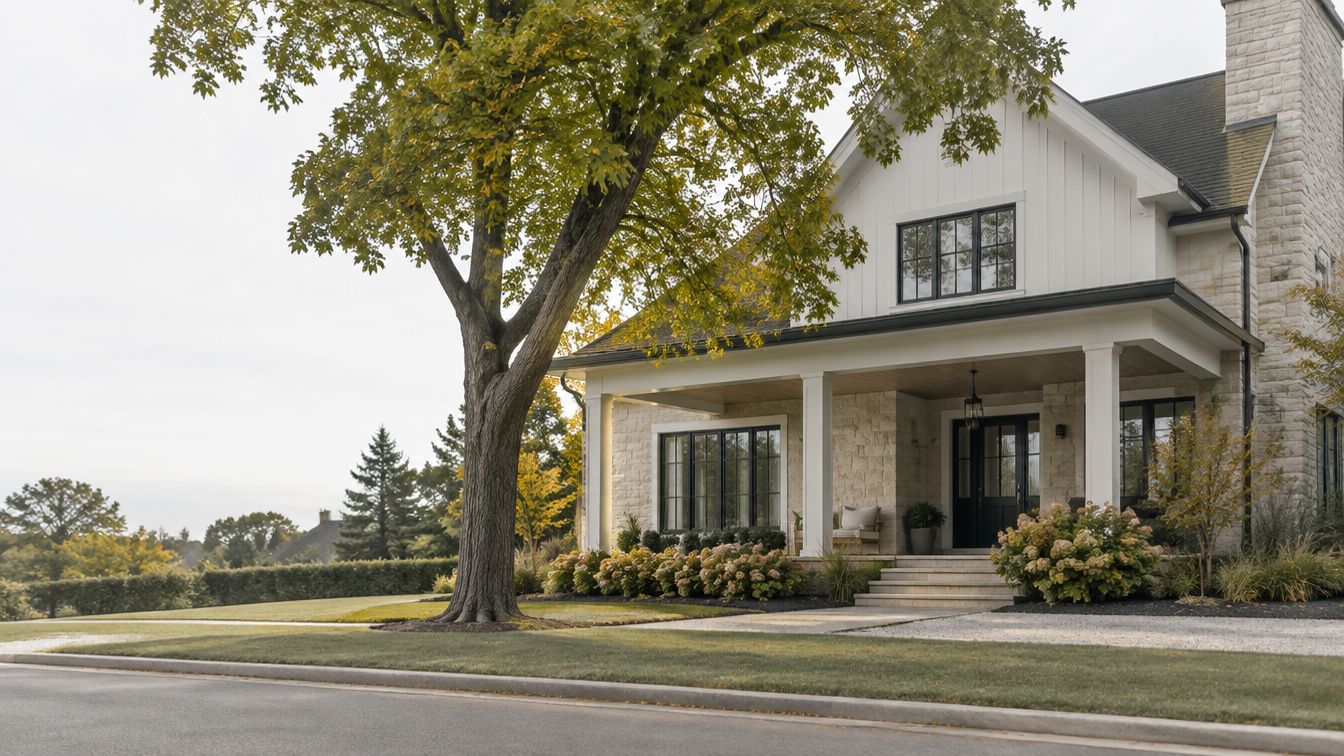 A lived-in modern family home with a covered porch and a mature maple tree
